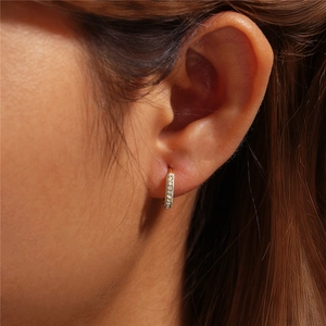 Close-up of s925 silver golden hoop earring with micro-set sparkling white cubic zirconia
