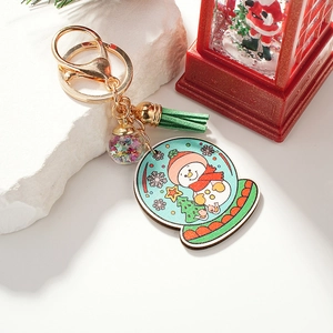 Christmas snowman keychain with green tassel and sparkling glitter ball on white stone