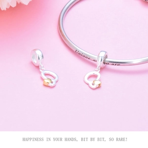 Close-up of S925 sterling silver heart charm with 'Unique as you are' engraved bracelet