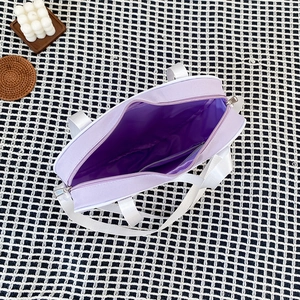 Detailed view of the lavender heart bag interior with zipper pocket and purple lining