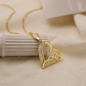 Detail of a gold heart pendant necklace featuring micro-set zircon and love engraving
