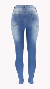 Close-up of back pockets and lifting cut on light blue skinny distressed denim jeans