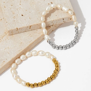 Detailed shot of layered freshwater pearl bracelets with gold and silver bead accents