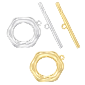 Macro view of gold and silver textured toggle clasps for jewelry making components