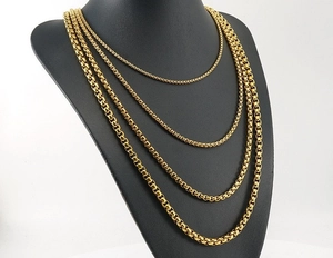 Detail showing four different thicknesses of gold 18K stainless steel box chain necklaces
