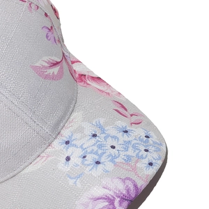 Close-up of floral print patterns on grey baseball cap with detailed woven fabric texture