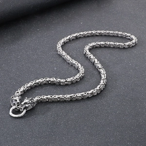 Detailed close-up of heavy-duty stainless steel square box chain with double lion heads