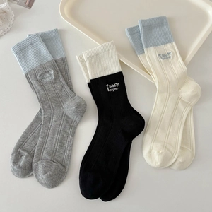 Three pairs of cotton crew socks with bow and Bébé Bonjour embroidery on white tray