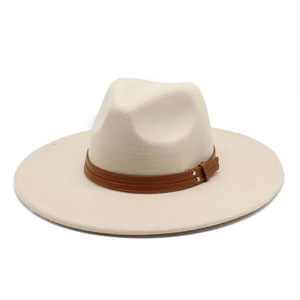 Detail of cream white felt fedora hat featuring a brown leather band and silver studs