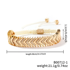 Detail view of geometric V-shaped gold bracelet with zircons and adjustable white cord