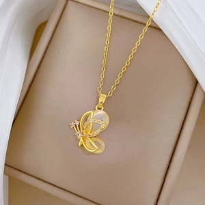Elegant gold butterfly necklace with cat eye stone and diamonds on silk background