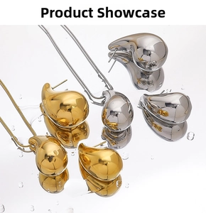 Close-up of gold and silver bean-shaped earrings and necklace with mirror polish finish
