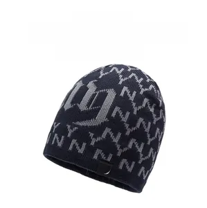 Close-up of thick winter knit hat showing blue navy fabric and detailed NY logo patterns