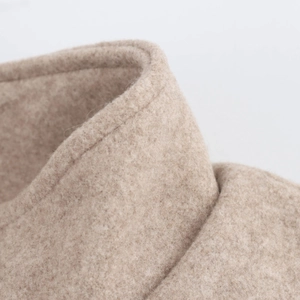 Close-up of beige wool pilot jacket collar showing soft texture and premium stitching