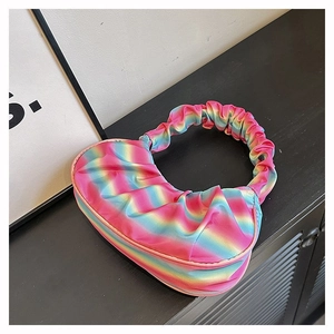 Close-up of rainbow gradient pleated shoulder bag with satin finish and cloud texture