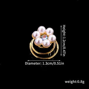 Detail of bridal pearl hair spiral clip with dimensions and rhinestones on black background