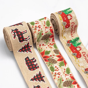 Detail of burlap Christmas ribbons with reindeer and truck prints for holiday gift wrapping