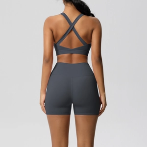 Detail of cross-back sports bra and high-waisted shorts in dark grey matte fabric
