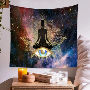 Detail of wall tapestry featuring yoga meditation silhouette and blue eye in starry sky