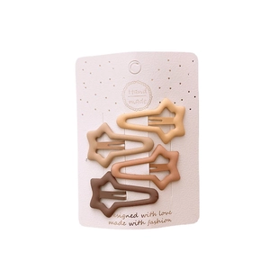 Set of four star-shaped matte snap hair clips in earthy brown and beige tones