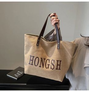 Close-up of retro brown canvas tote bag with HONGSH lettering and large capacity