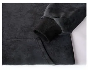 Detail of ribbed cuffs and matte textured fabric on a dark tie-dye hoodie sweatshirt