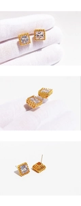Macro detail of geometric square zircon ear cuffs with intricate hollow gold settings