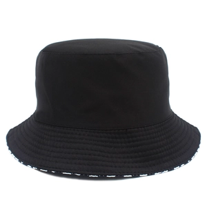 Front view of a minimalist black cotton bucket hat with a clean silhouette on white background