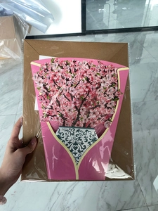 Detailed view of 3D pop-up cherry blossom flower bouquet card in transparent packaging