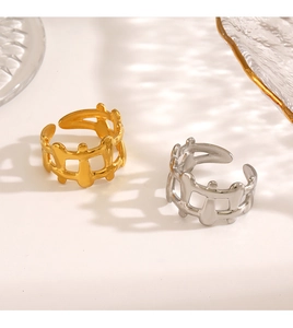 Detail of 18K gold and silver plated hollow geometric rings in a modern woven design