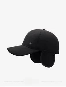Detail of winter baseball cap featuring honeycomb knit texture and metal badge accent