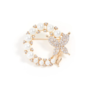 Elegant gold butterfly brooch with white pearls and sparkling rhinestones on white background