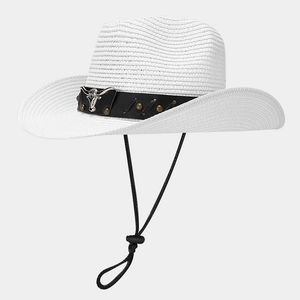 Detail of white woven cowboy hat featuring a silver bull head and black leather band