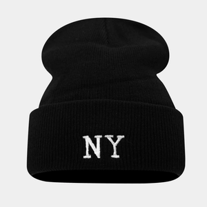Detailed close-up showing the NY embroidery and thick knit texture of the black beanie hat