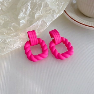 Neon pink twisted hoop earrings with ribbed rectangular stud in high-impact matte finish