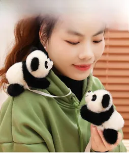 Cute plush panda doll accessory shown on shoulder and hand with soft black and white fur