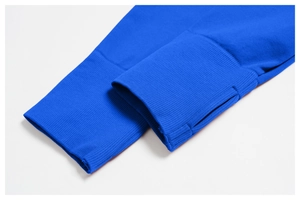 Close-up of royal blue ribbed yoga jacket cuff featuring a functional thumbhole design