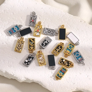 Detailed macro view of 18K gold and silver plated tarot pendants with enamel and rhinestones