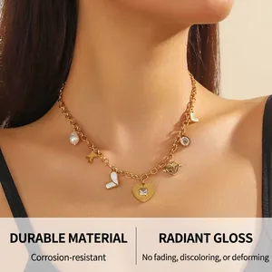 Detail of gold chain necklace featuring butterfly, pearl, and crystal heart pendants