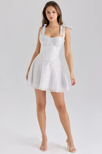Detailed view of the corset bodice and tie-straps on a white polka dot chiffon dress