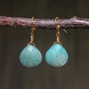 Macro detail of teardrop faceted amazonite stone earrings with hand-wrapped gold wire