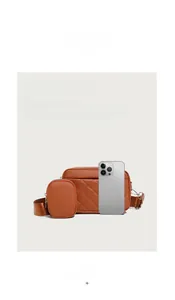 Close-up of quilted tan leather crossbody bag set with detachable round coin purse