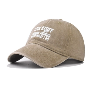 Close-up of vintage washed khaki cotton baseball cap with white slogan printing