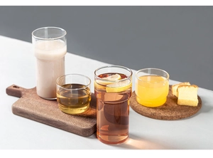 Stackable borosilicate glass cups on a wooden tray with lemon and toast for tea time