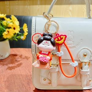 Traditional Tang Dynasty style doll keychain on a white bag with floral basket charm