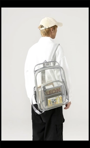 Close-up of clear PVC backpack showing large main compartment and side mesh pockets