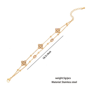 Detail of double-layer stainless steel bracelet with white crystal clover pendants