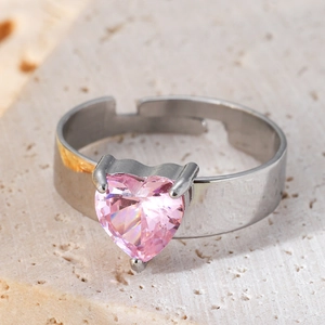 Silver stainless steel open ring with a large heart-shaped pink zircon on stone background