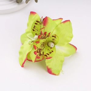 Macro detail of artificial cymbidium orchid hair clip with vibrant purple petal edges