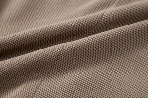 Vue macro de la texture du tissu gaufré kaki de haute qualité sur un blazer ajusté